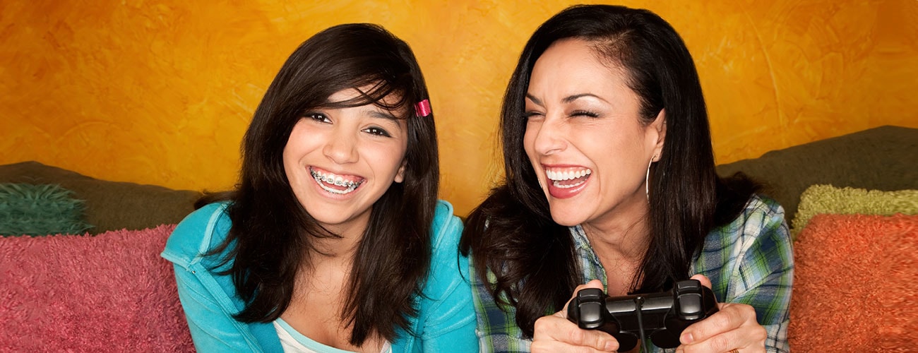 Fabulous Smiles Orthodontics Mother Daughter Smiling Paying Video Games